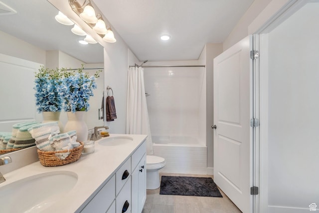 bathroom with toilet, a sink, double vanity, and shower / tub combo