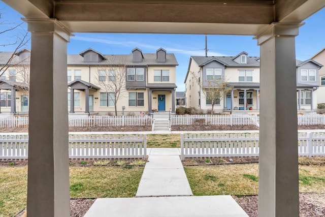 view of front of house featuring fence and a residential view