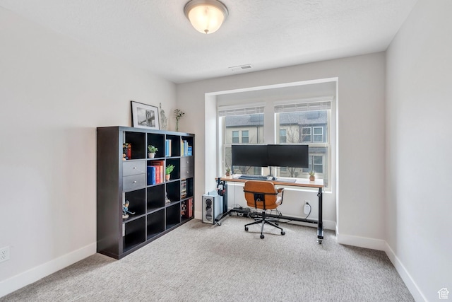 office area featuring baseboards, visible vents, and carpet