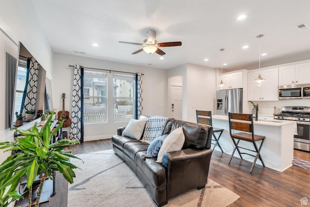living area featuring visible vents, recessed lighting, a ceiling fan, and dark wood finished floors