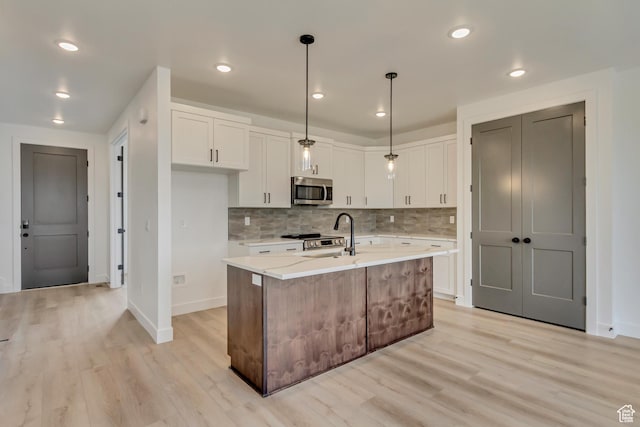 1344 N 1525 E Unit 73, Payson, UT 84651 - kitchen with white cabinets, light wood finished floors, and stainless steel appliances