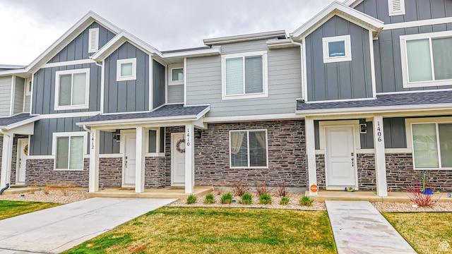 1410 S Divide Dr Unit 144, Santaquin, UT 84655 - view of front of home with stone siding, a front lawn, and board and batten siding