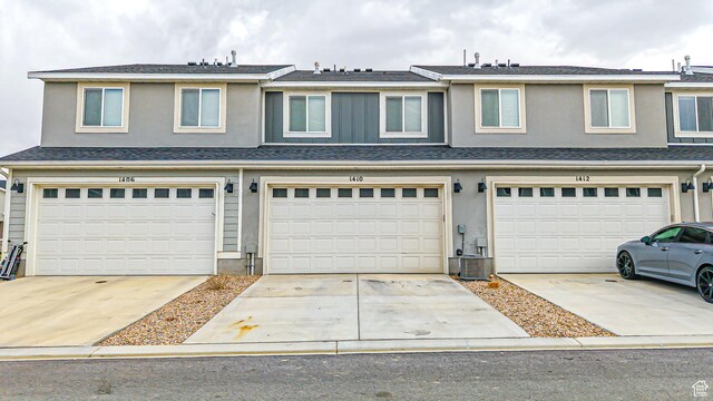 1410 S Divide Dr Unit 144, Santaquin, UT 84655 - view of property featuring a shingled roof, concrete driveway, stucco siding, and an attached garage