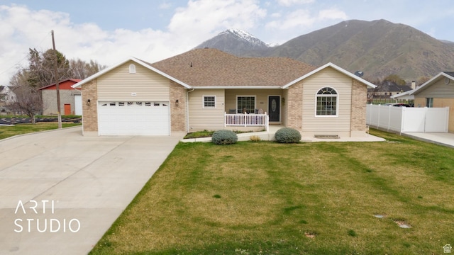 ranch-style home featuring fence, an attached garage, driveway, a front lawn, and a porch