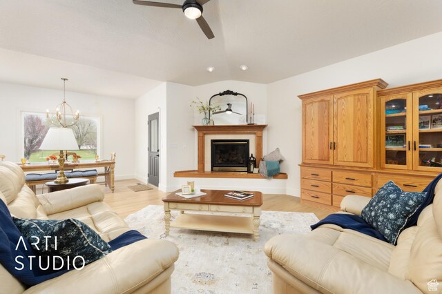 486 W 1200 N, Mapleton, UT 84664 - living room featuring baseboards, a glass covered fireplace, light wood-style floors, and ceiling fan with notable chandelier