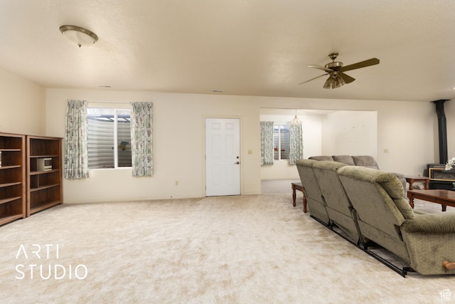 486 W 1200 N, Mapleton, UT 84664 - living room with a wood stove, carpet, and a ceiling fan
