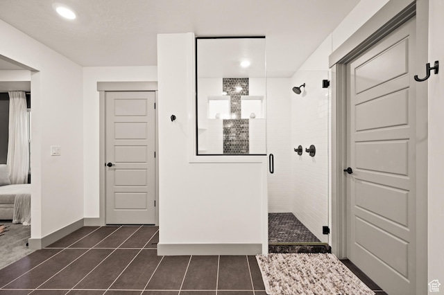 274 S Hayes Well Ln, Saratoga Springs, UT 84045 - ensuite bathroom featuring a shower stall, baseboards, connected bathroom, and tile patterned flooring