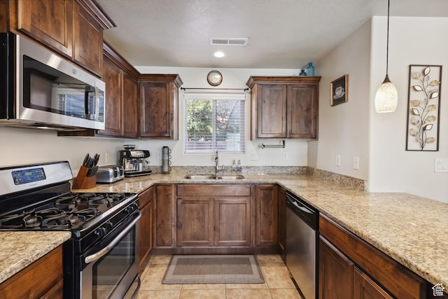 6212 W 100 S, Hurricane, UT 84737 - kitchen featuring visible vents, light stone counters, a sink, and stainless steel appliances