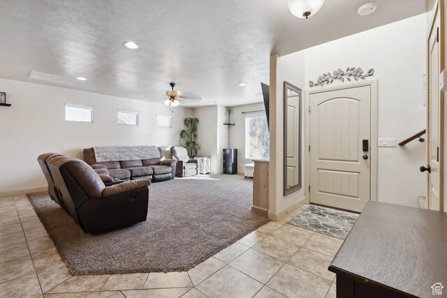 6212 W 100 S, Hurricane, UT 84737 - living room featuring light tile patterned floors, baseboards, a ceiling fan, and light carpet