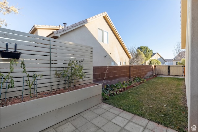 6212 W 100 S, Hurricane, UT 84737 - view of home's exterior featuring a fenced backyard, stucco siding, and a yard
