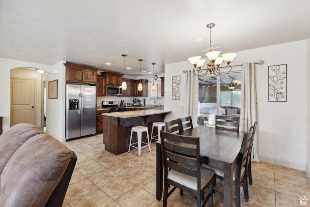6212 W 100 S, Hurricane, UT 84737 - dining area featuring baseboards, recessed lighting, arched walkways, an inviting chandelier, and light tile patterned floors