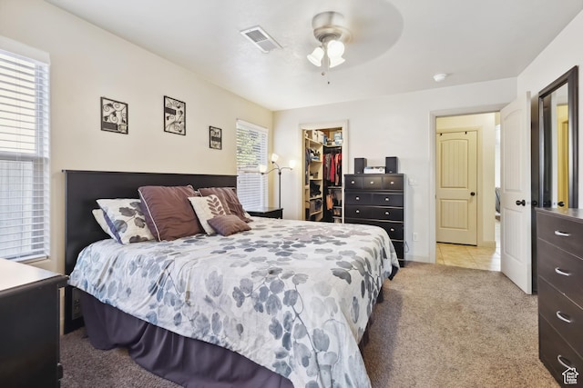 6212 W 100 S, Hurricane, UT 84737 - bedroom featuring a walk in closet, visible vents, a ceiling fan, light carpet, and a closet