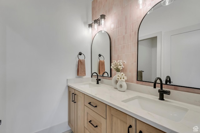full bathroom with double vanity and a sink