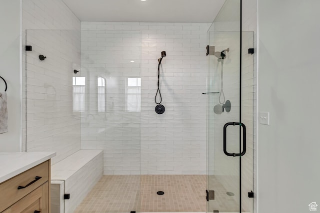 full bathroom with vanity and a shower stall