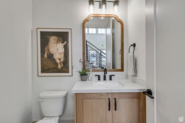 bathroom featuring toilet and vanity