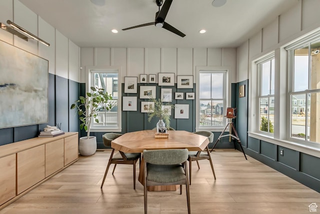 dining area with recessed lighting, light wood-style flooring, ceiling fan, and a decorative wall