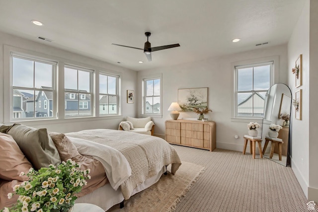 carpeted bedroom featuring baseboards, visible vents, recessed lighting, and a ceiling fan