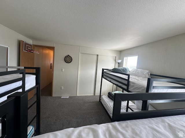 3068 S Monarch Cir Unit 343, Garden City, UT 84028 - carpeted bedroom with a textured ceiling and a closet