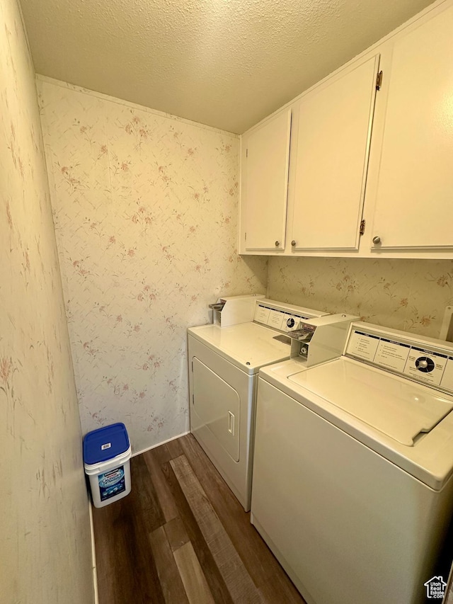 3068 S Monarch Cir Unit 343, Garden City, UT 84028 - laundry area featuring dark wood-style flooring, washing machine and clothes dryer, cabinet space, a textured ceiling, and wallpapered walls
