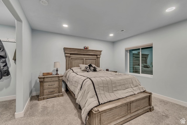 bedroom featuring baseboards, visible vents, recessed lighting, and light carpet