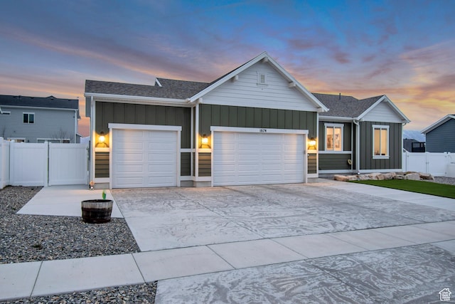 view of front of property with fence, driveway, a garage, and board and batten siding