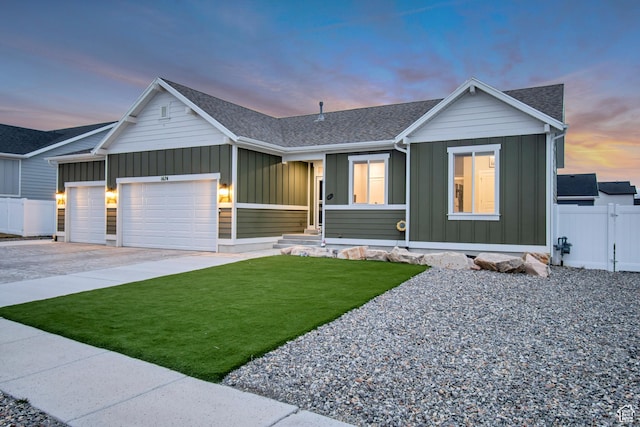 view of front of house featuring fence, an attached garage, a front lawn, board and batten siding, and driveway
