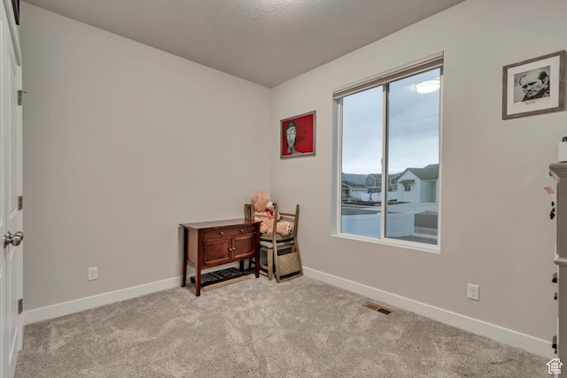 interior space with carpet, baseboards, and visible vents