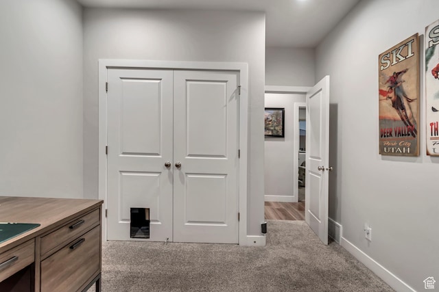 interior space with baseboards and carpet flooring