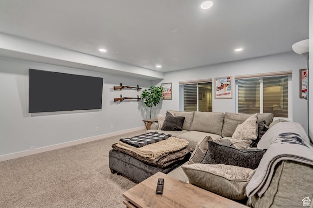 carpeted living room featuring baseboards and recessed lighting