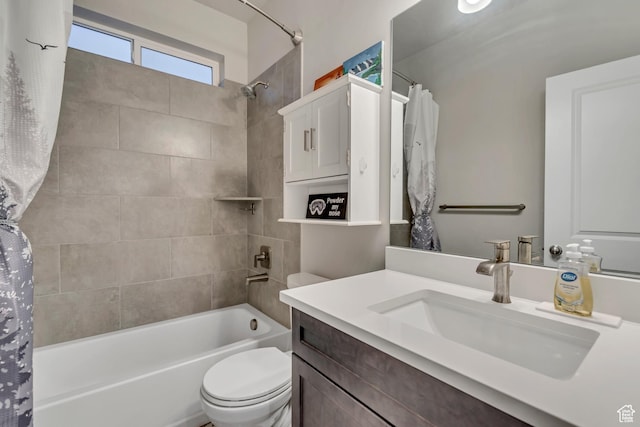 bathroom featuring toilet, vanity, and shower / tub combo with curtain