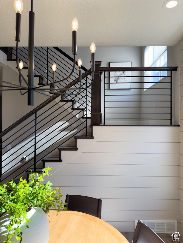 4436 W 1050 S Unit 104, West Point, UT 84015 - staircase with visible vents and an inviting chandelier