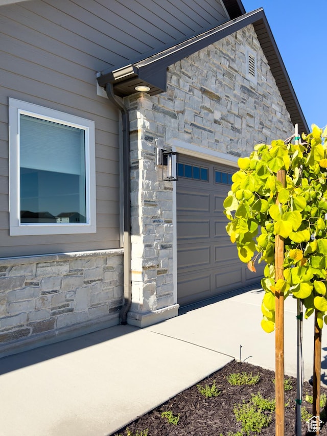 4436 W 1050 S Unit 104, West Point, UT 84015 - entrance to property with stone siding and a garage