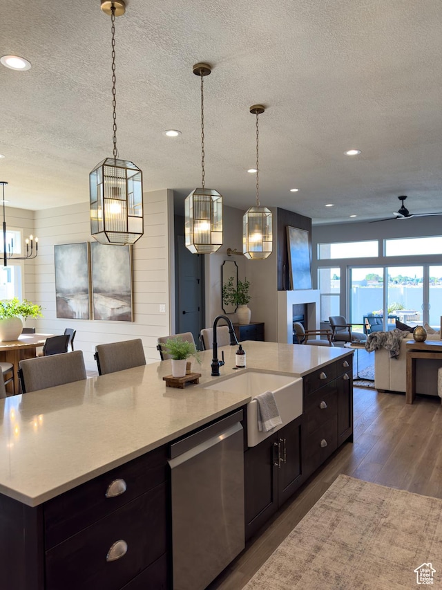 4436 W 1050 S Unit 104, West Point, UT 84015 - kitchen with open floor plan, ceiling fan with notable chandelier, stainless steel dishwasher, a sink, and wood finished floors