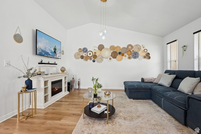 1022 W Allington Dr N, North Salt Lake, UT 84054 - living area with a glass covered fireplace, baseboards, vaulted ceiling, and wood finished floors