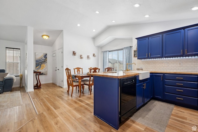 1022 W Allington Dr N, North Salt Lake, UT 84054 - kitchen with dishwasher, wooden counters, blue cabinetry, a sink, and vaulted ceiling