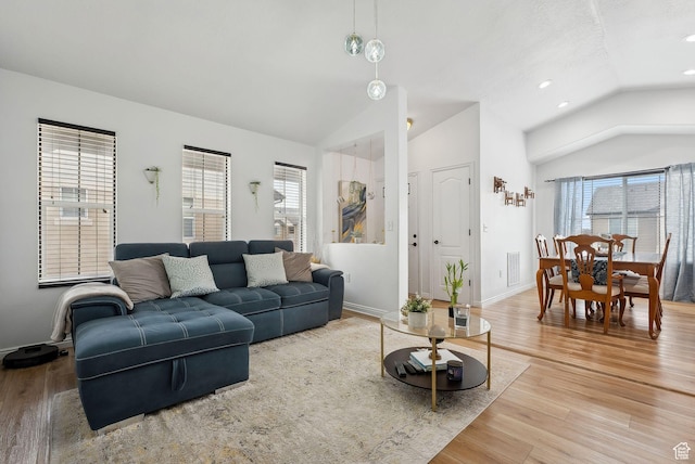 1022 W Allington Dr N, North Salt Lake, UT 84054 - living area with baseboards, wood finished floors, vaulted ceiling, and plenty of natural light