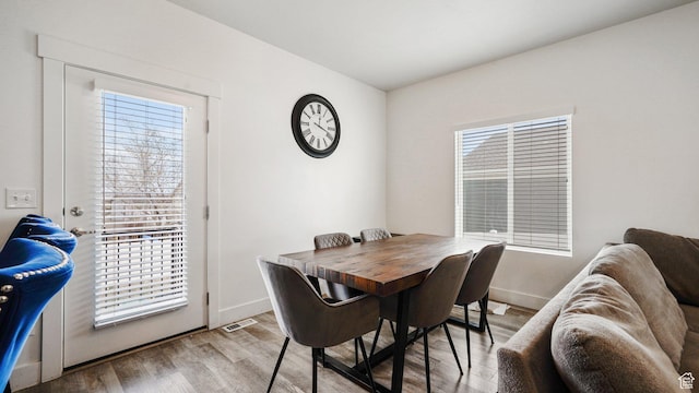 7756 W Bellfield Rd, Magna, UT 84044 - dining room with baseboards, visible vents, and wood finished floors