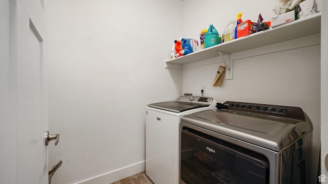7756 W Bellfield Rd, Magna, UT 84044 - laundry area with light wood finished floors, baseboards, washing machine and dryer, and laundry area