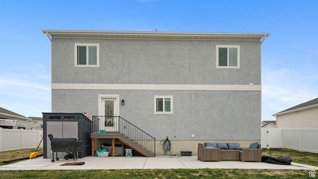 7756 W Bellfield Rd, Magna, UT 84044 - back of property featuring a fenced backyard, stucco siding, an outdoor living space, and a patio