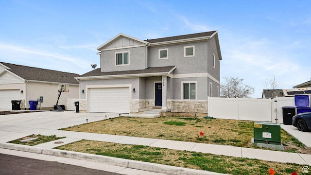7756 W Bellfield Rd, Magna, UT 84044 - view of front of property with stone siding, fence, an attached garage, concrete driveway, and board and batten siding