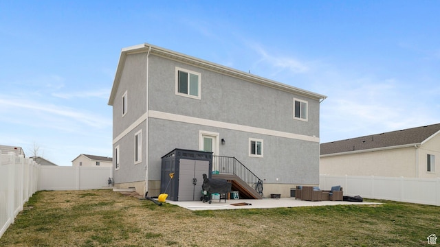 7756 W Bellfield Rd, Magna, UT 84044 - back of property featuring a fenced backyard, stucco siding, a yard, and a patio area