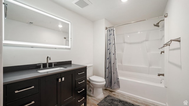 7756 W Bellfield Rd, Magna, UT 84044 - full bath with visible vents, toilet, wood finished floors, vanity, and shower / bath combo with shower curtain