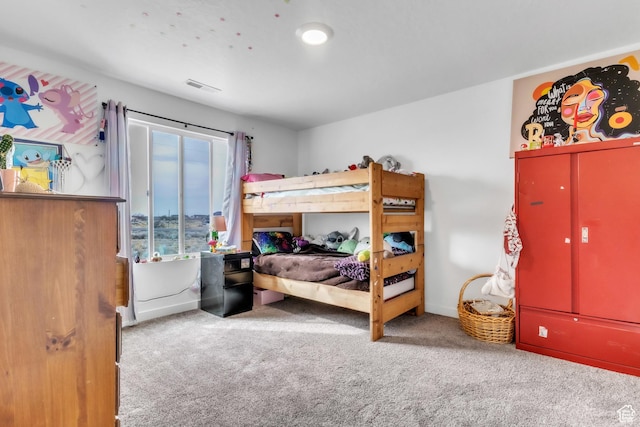 carpeted bedroom with baseboards and visible vents