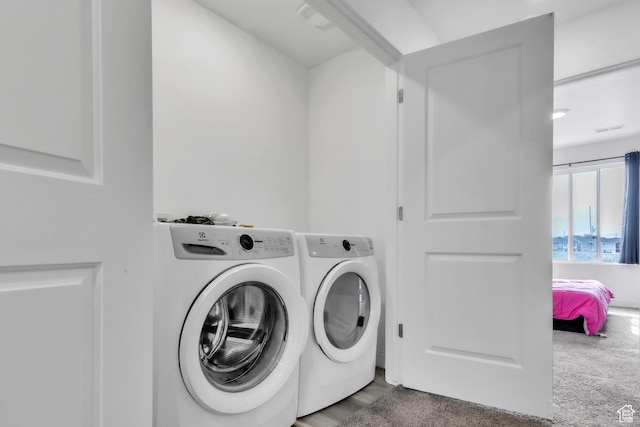 washroom with separate washer and dryer and laundry area