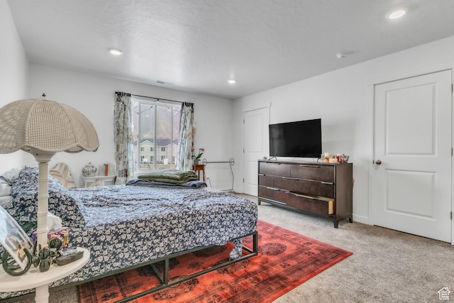 bedroom featuring visible vents, baseboards, light colored carpet, and recessed lighting