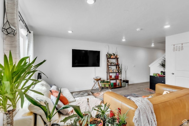 living room with wood finished floors and recessed lighting
