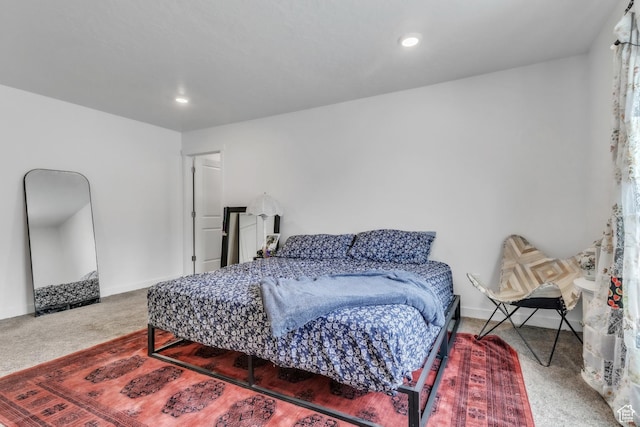 carpeted bedroom featuring baseboards and recessed lighting