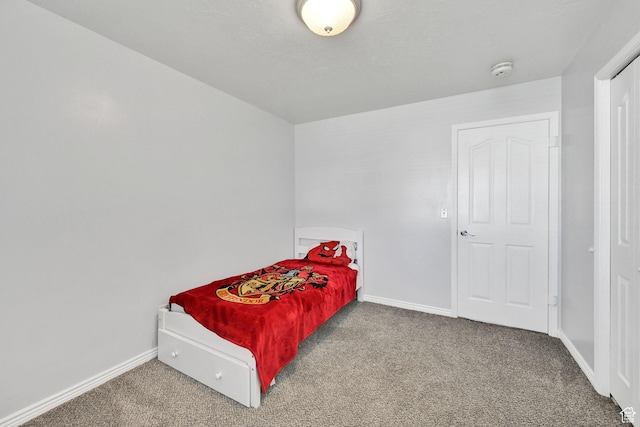 bedroom with baseboards and carpet