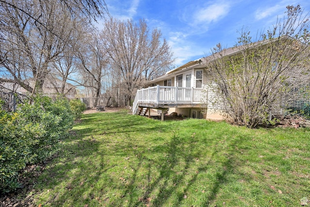 view of yard with a wooden deck and stairs