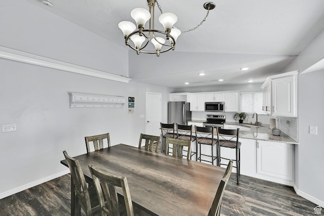 dining space with dark wood-type flooring, recessed lighting, an inviting chandelier, and vaulted ceiling